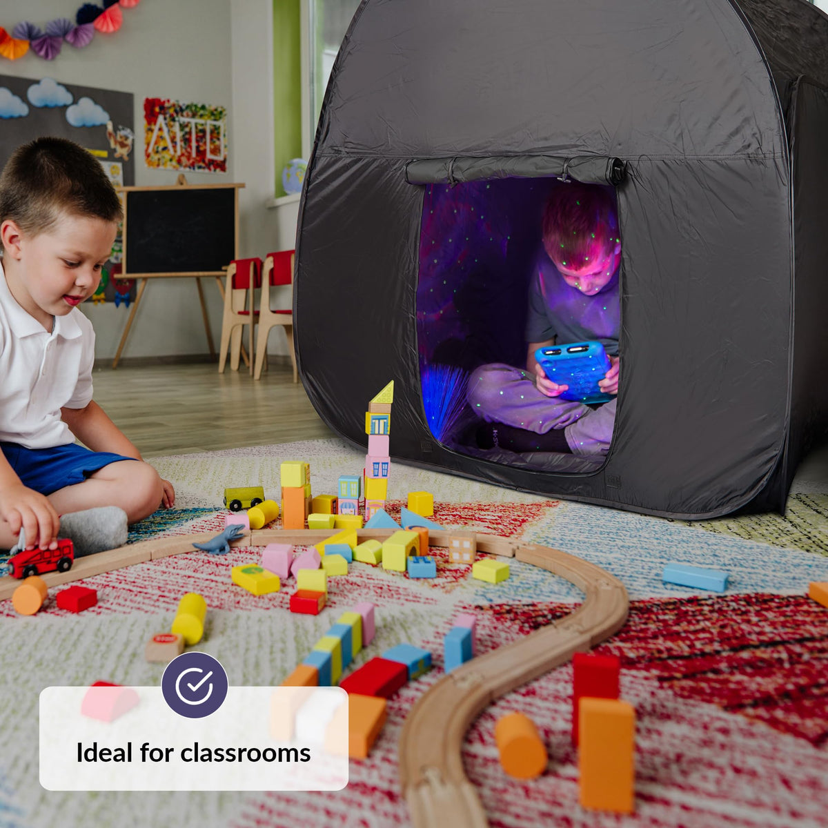 Inside the ODOXIA Sensory Tent, two children share a private play area.