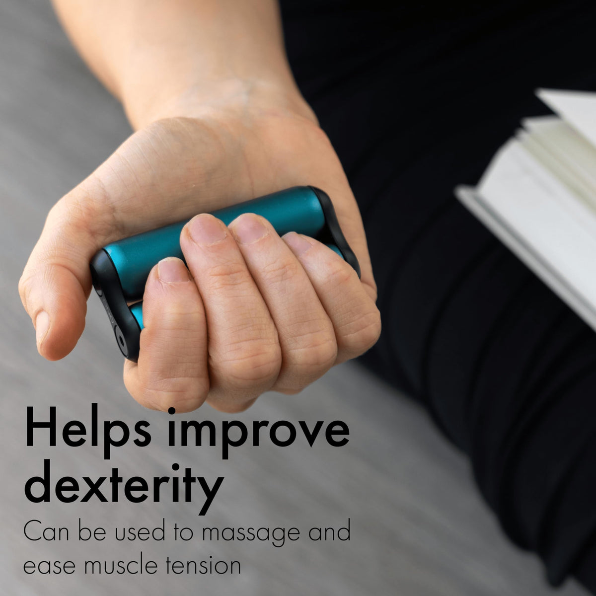 ONO Roller teal mini in hand demonstrates portable stress relief during work