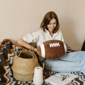 OurHonor Football Plush in use as multifunction decor for beds, desks, lounges.