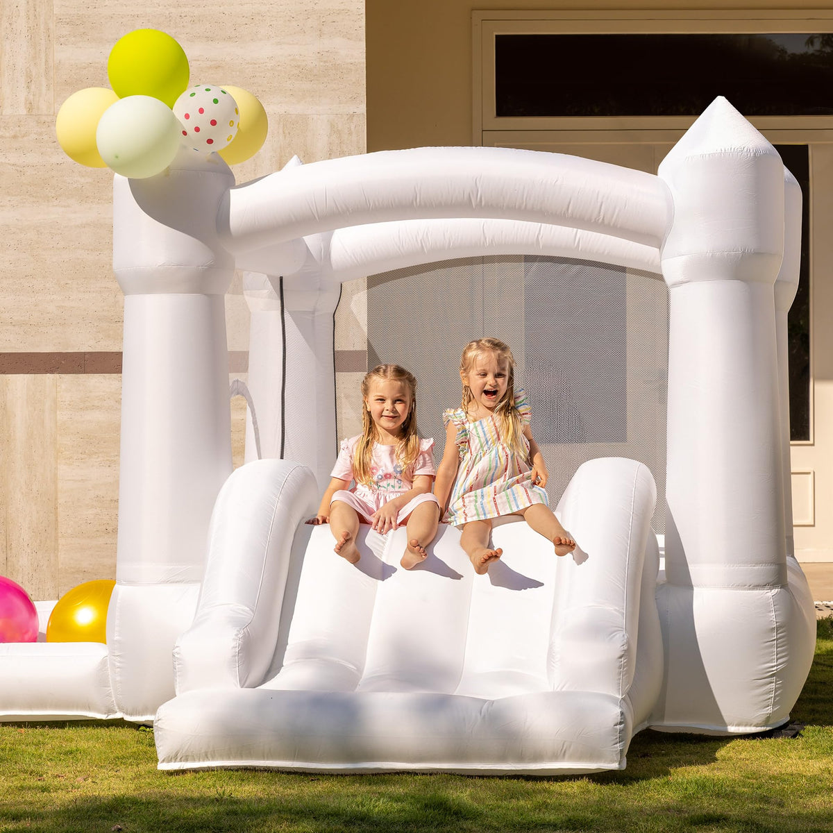 Outfunny white bounce house with slide offers safe indoor play for kids.