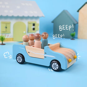 PairPear wooden family car in a cozy playroom scene.