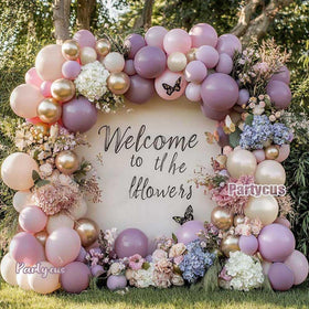 Partycus baby shower arch setup idea using dusty lavender and pink tones.