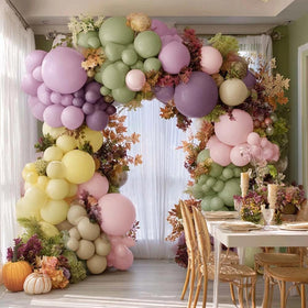 Partycus pastel yellow 5in balloons add subtle pops to the arch.