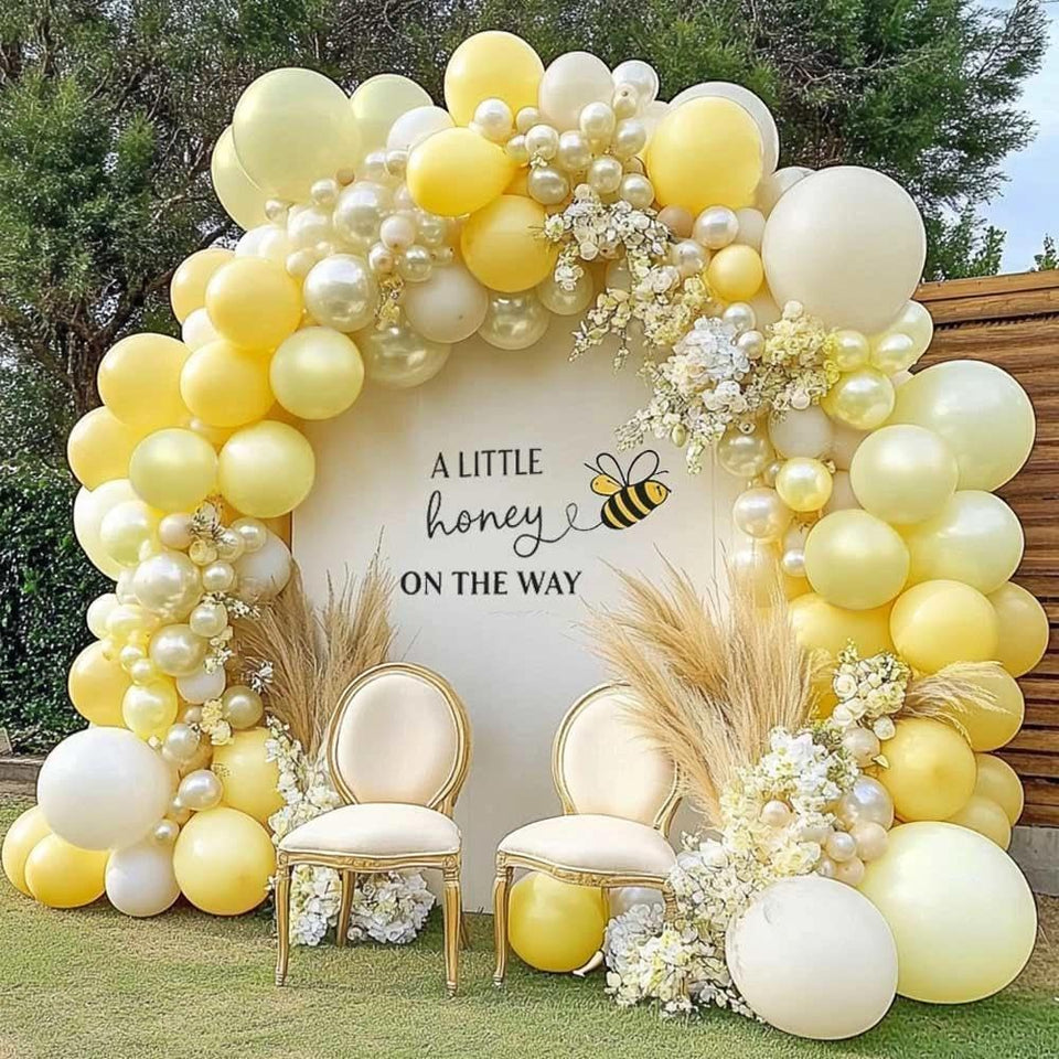 Partycus yellow arch kit with pastel yellow and pearl white balloons for a sunny backdrop.