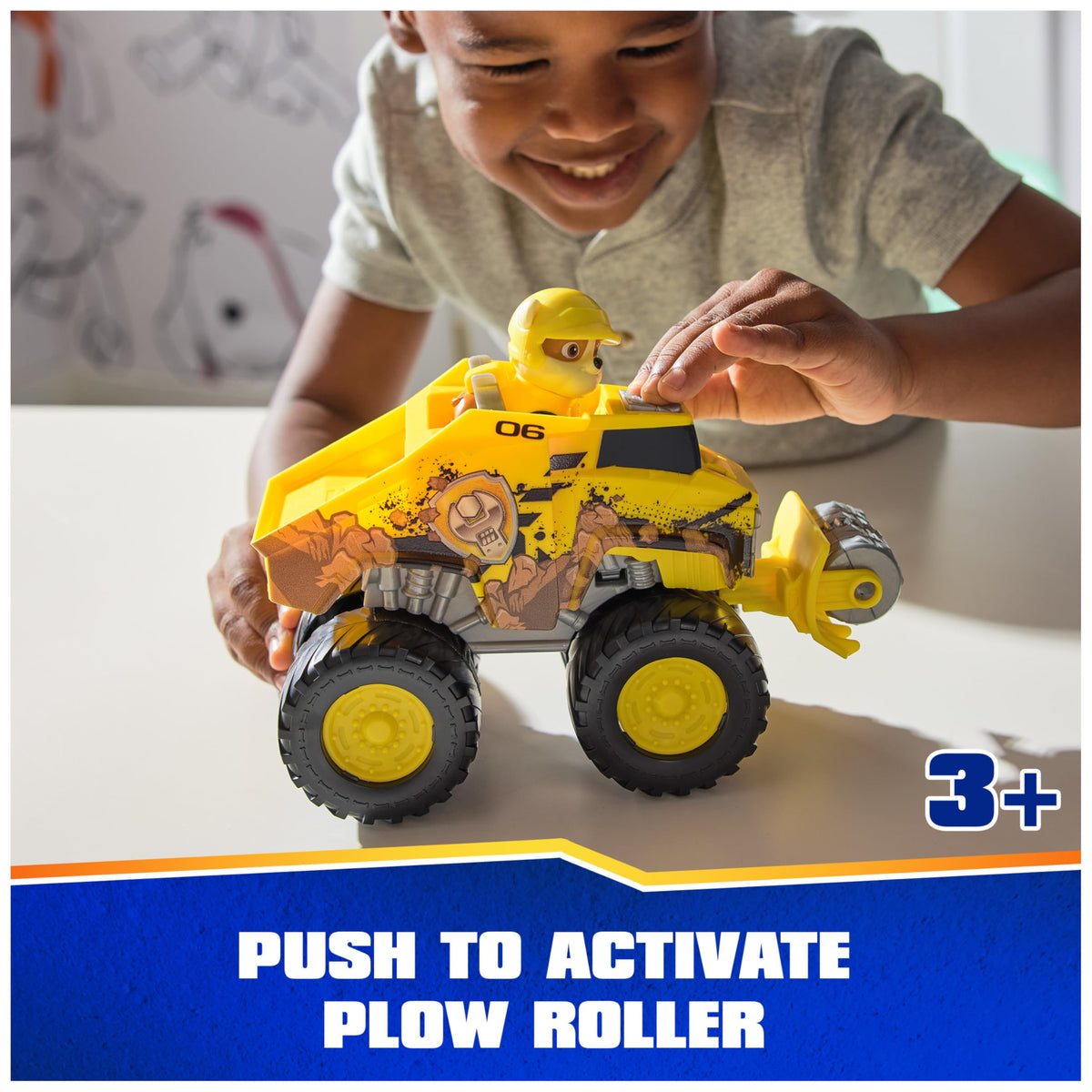 PAW Patrol Rubble figure perched in the driver seat for instant rescue missions.