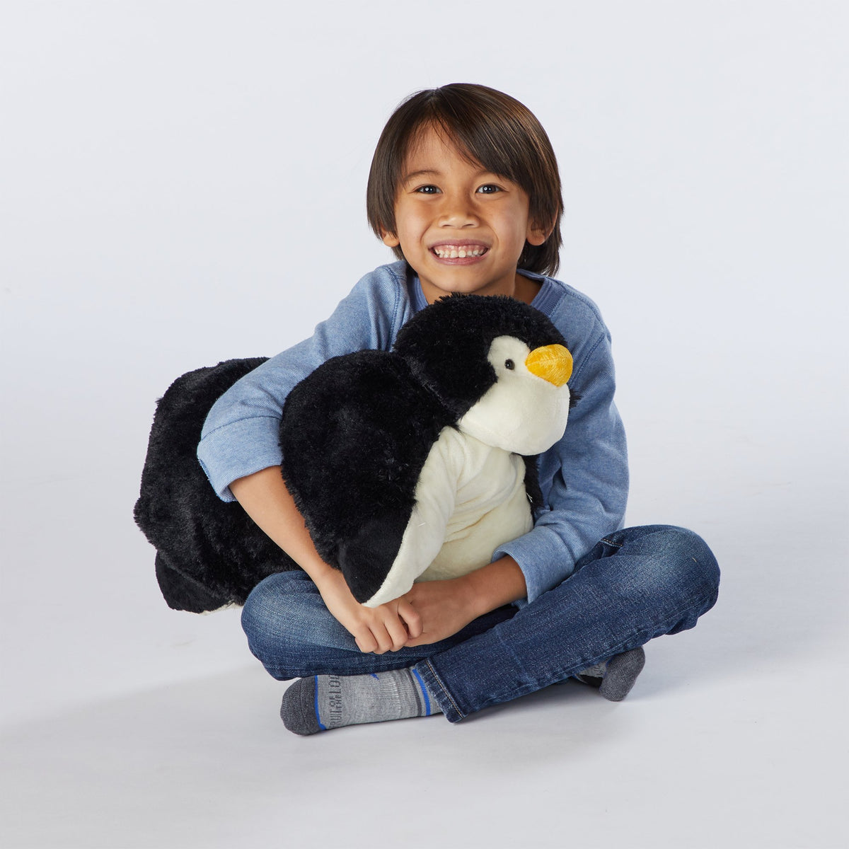 Pillow Pets Playful Penguin belly-velcro pillow conversion feature.