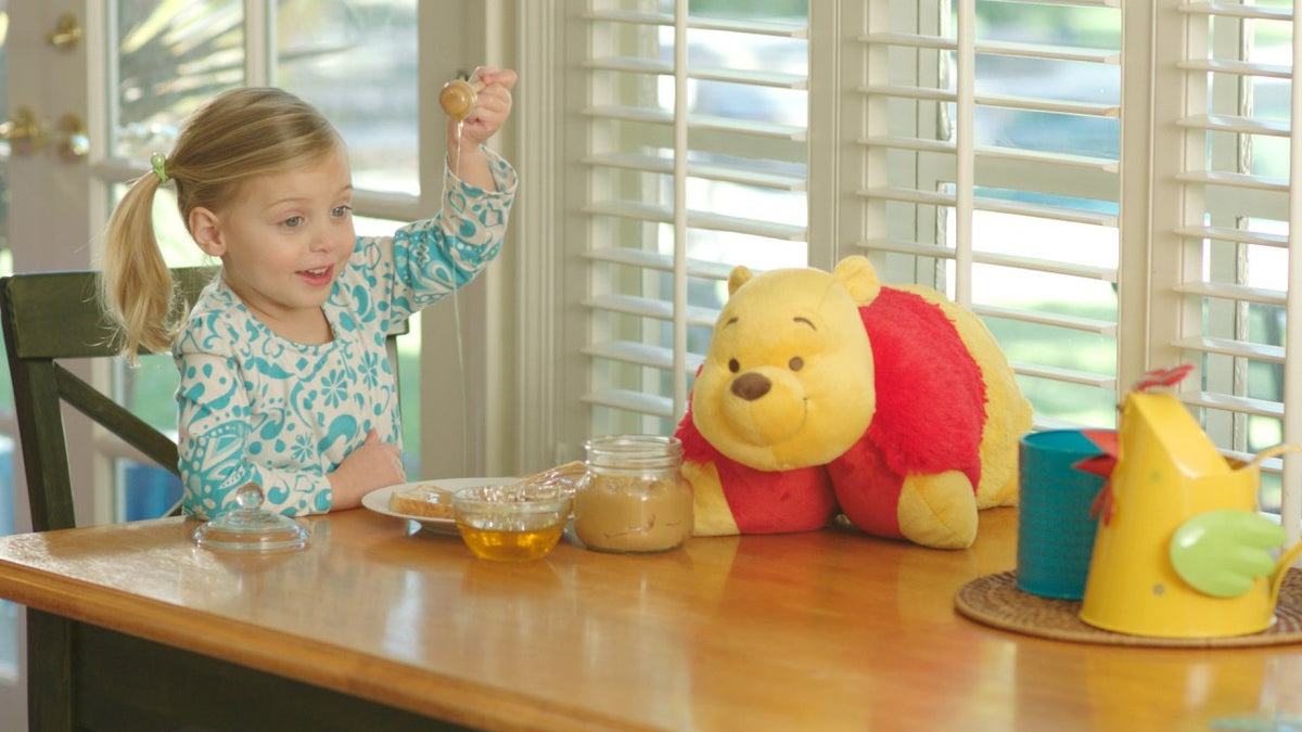 Pillow Pets Winnie the Pooh as a playful decor addition in a kids room.