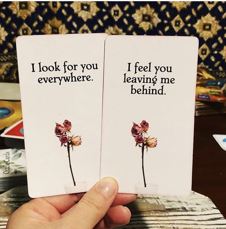 Pink-themed Hidden Truth Oracle deck resting on a table.