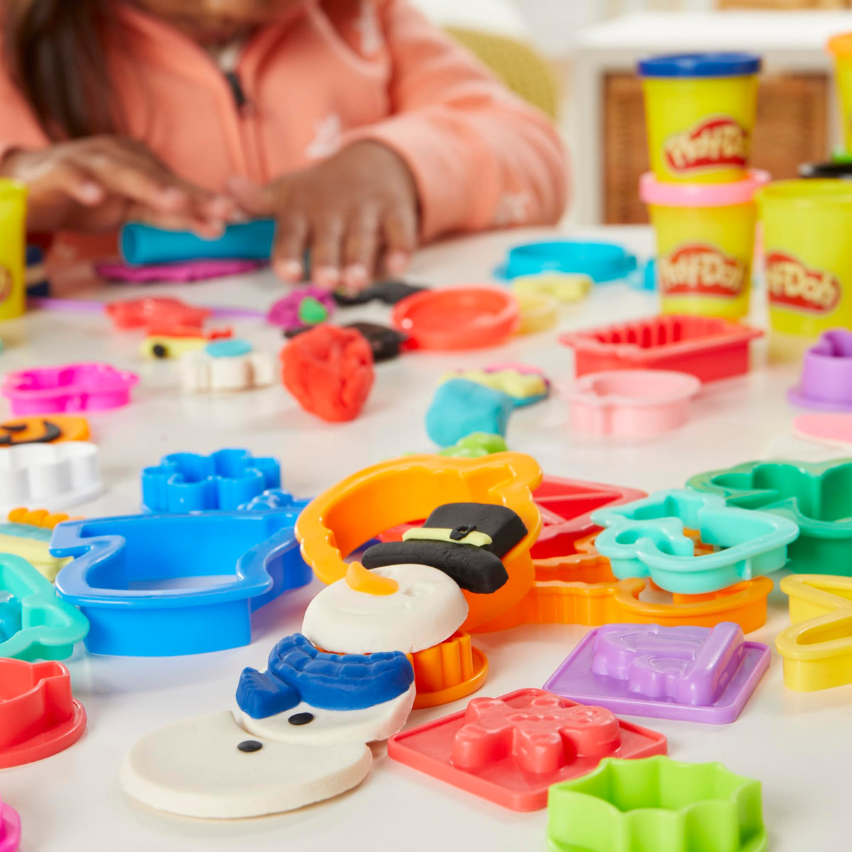 Play-Doh dreidel and Easter egg stamps spark themed craft activities.