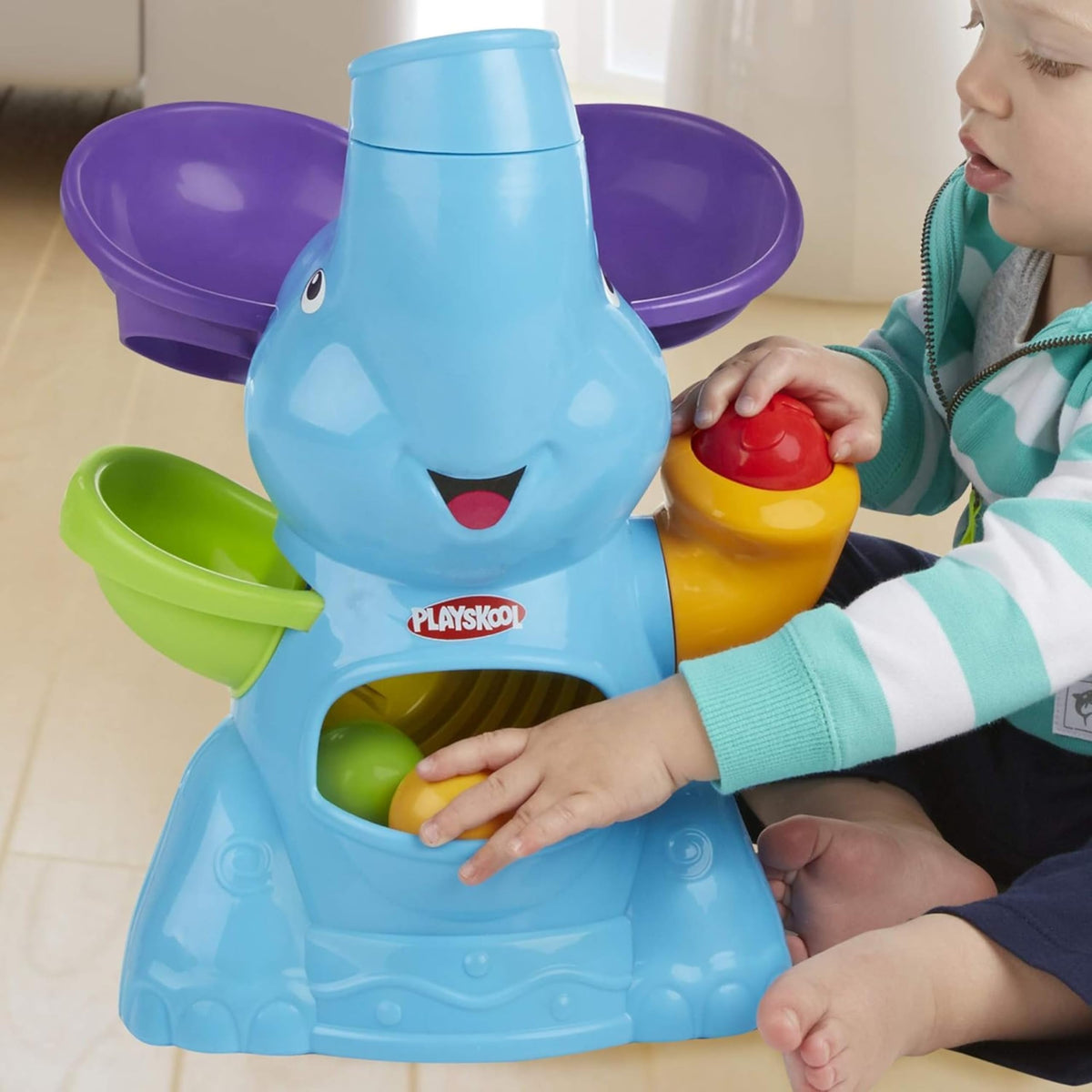 PlayMonster Elefun Busy Ball Popper ball-in-tummy moment invites retrieval play.
