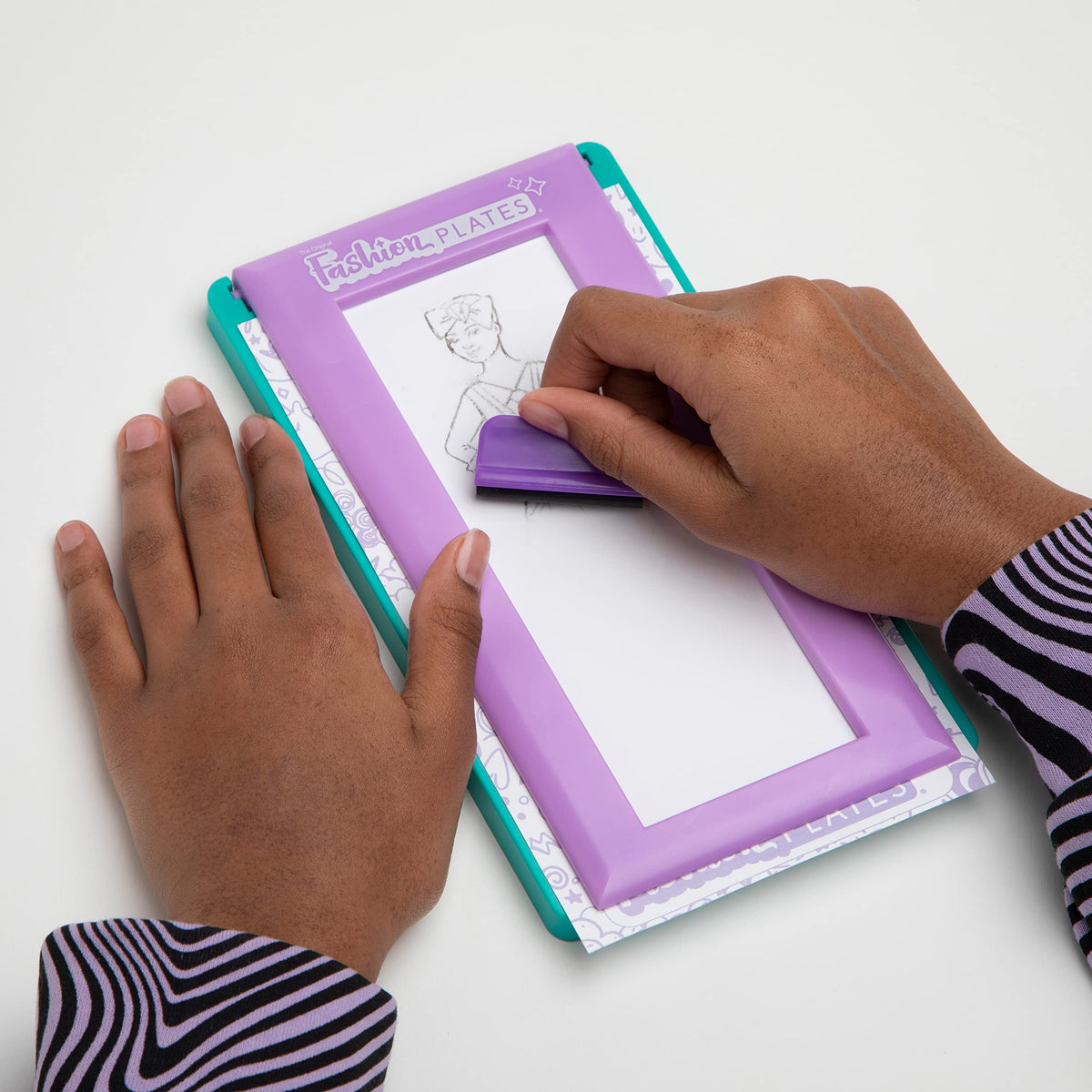 Travel-friendly tote stores plates and pencils for creativity on the go.