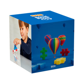Child hands stacking colorful pieces for motor skill development with Plus Plus Big.