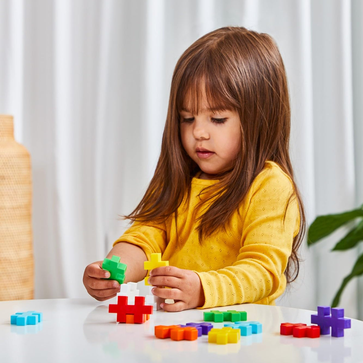 Plus-Plus Big piece in hand demonstrates toddler-friendly size for little hands.