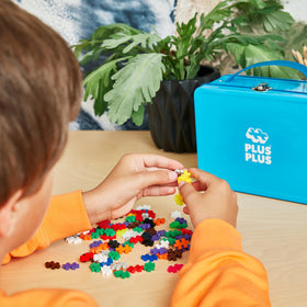 PLUS PLUS green baseplates provide a sturdy foundation for builds.