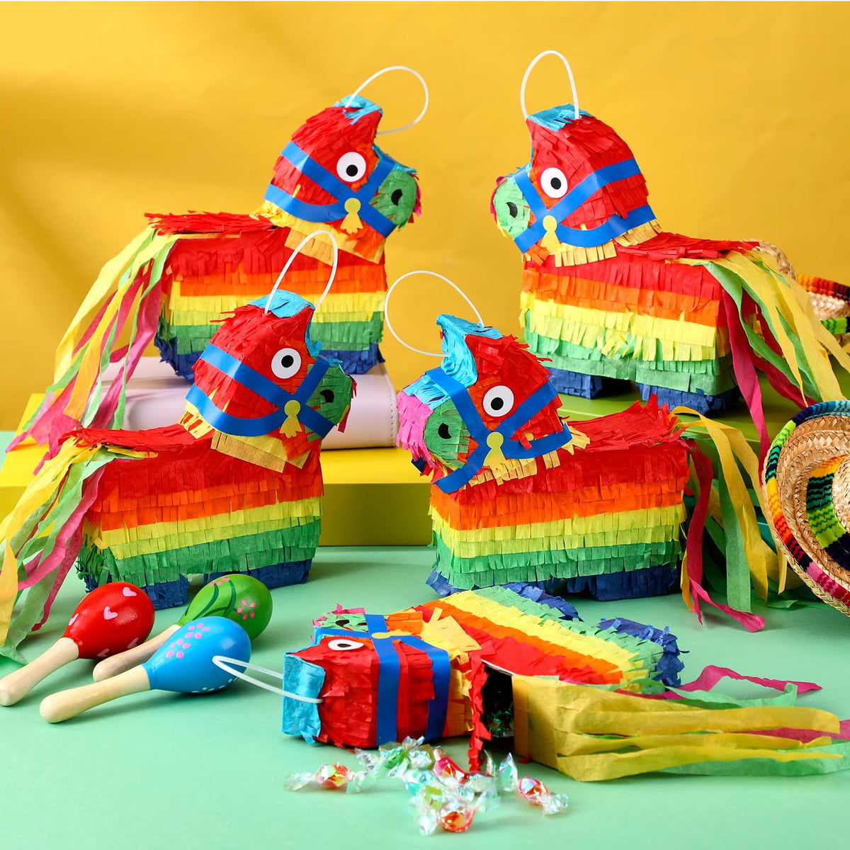 Poen mini donkey pinatas showcase rainbow hues for festive photos and party activities.