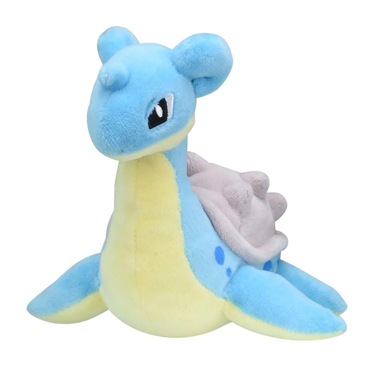 Pokémon Center Lapras Sitting Cuties Plush sits upright on a desk for a cute display.