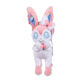 Pokemon Center Sylveon plush side view highlighting blue eyes and plush texture.