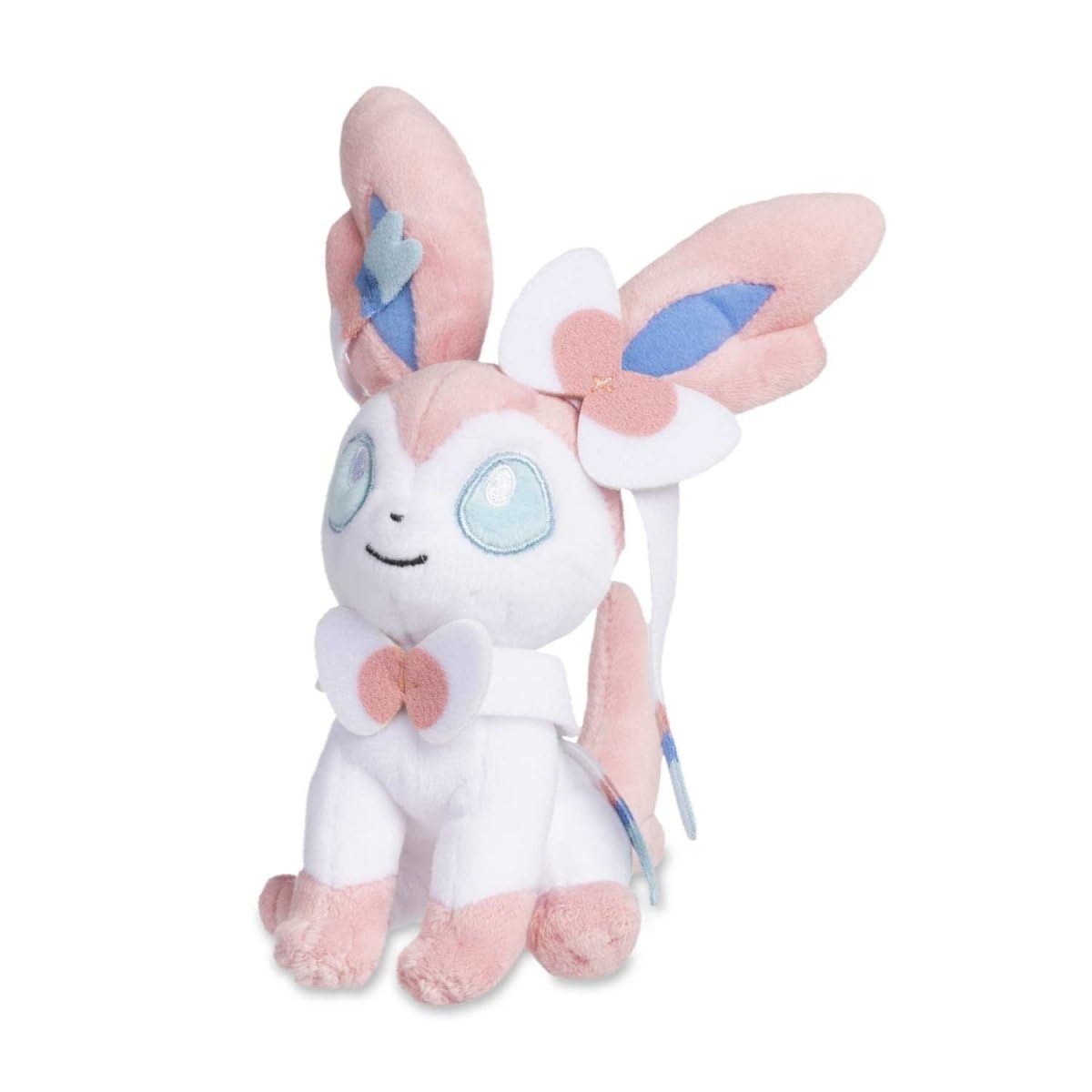 Pokémon Center Sylveon Sitting Cuties Plush on desk sits upright for display.