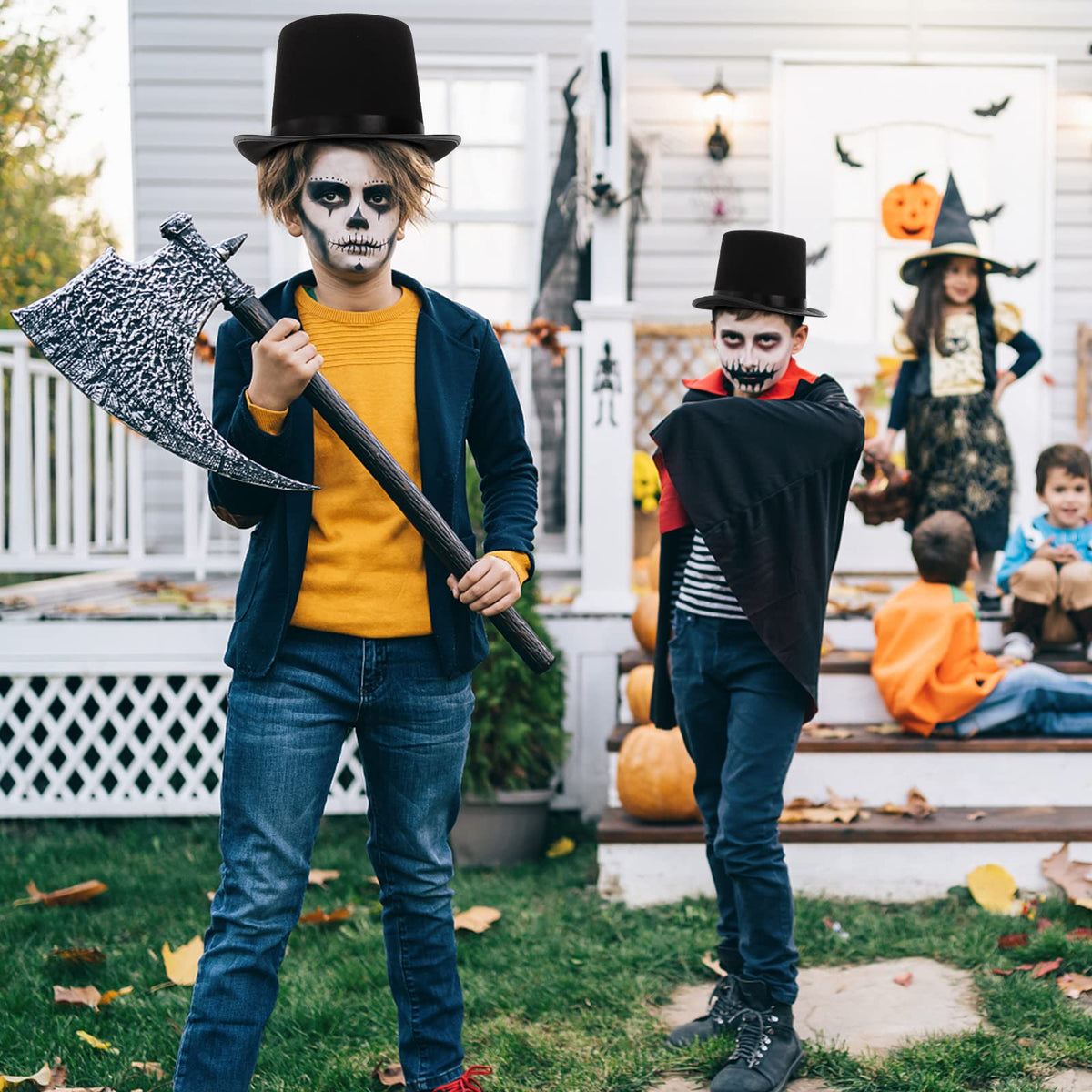 Pumtus kid wearing black felt top hat at a holiday party setup.