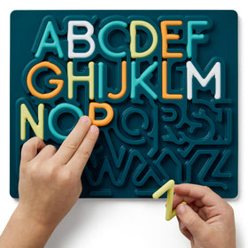 Pushpeel soft silicone strings enable tactile tracing during alphabet play and sensory focus.