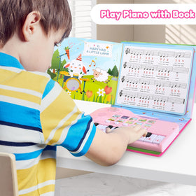 Quimsity piano book being played by a child, joyful learning in action.