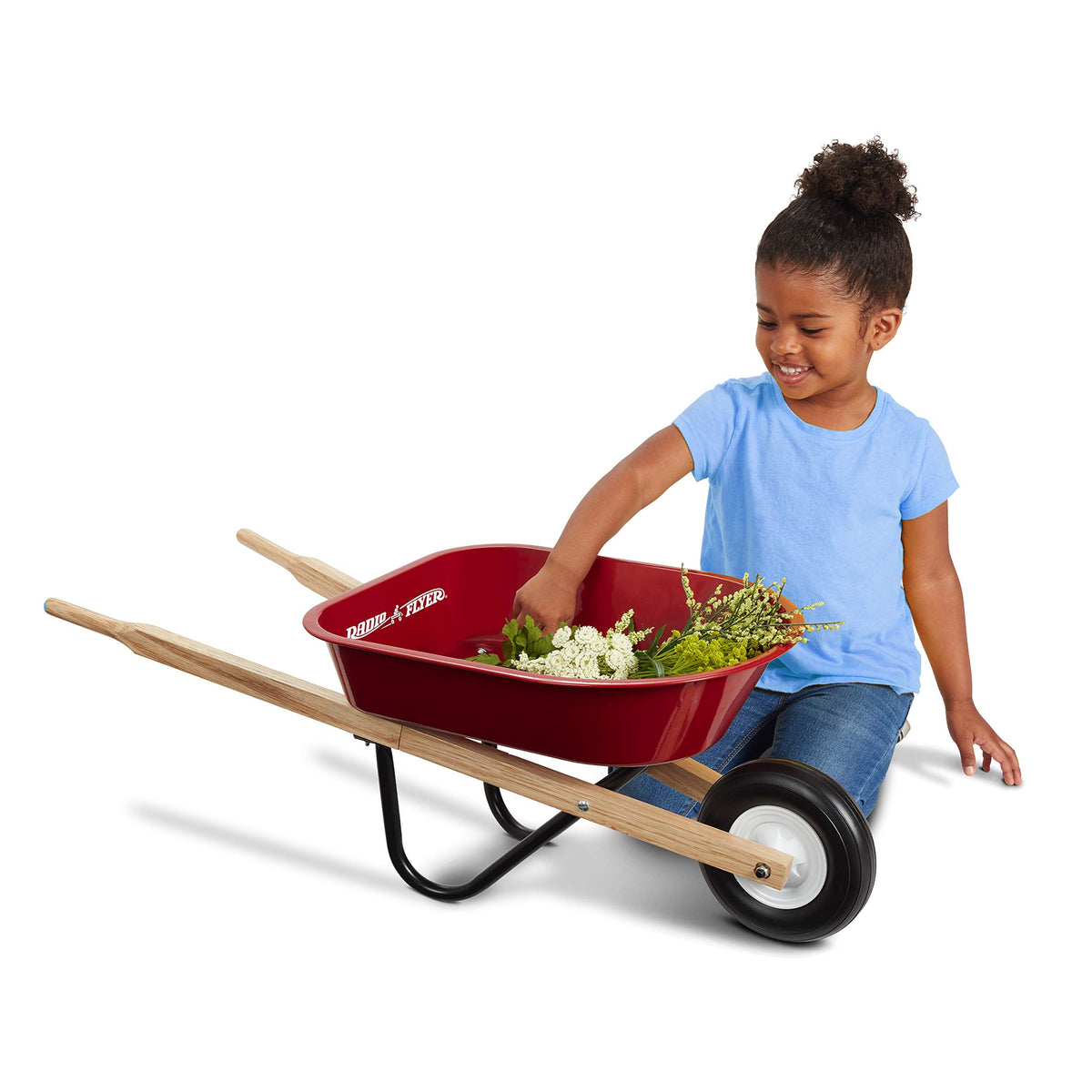 Radio Flyer Classic Kids Wheelbarrow in use—young helpers push toys and garden treasures.
