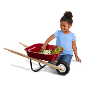 Radio Flyer Classic Kids Wheelbarrow in use—young helpers push toys and garden treasures.