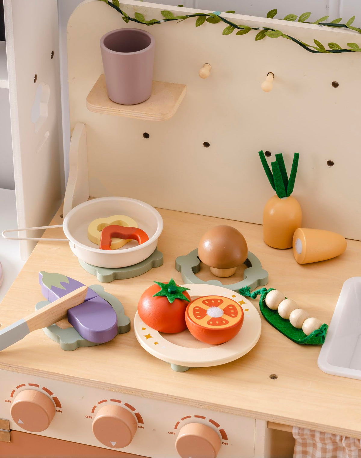 ROBUD wooden knife for safe slicing during pretend cooking.