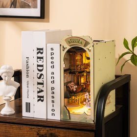 Rolife Falling Sakura book nook kit, side view, adds charm to a bookshelf corner