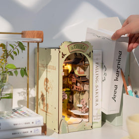 Rolife Falling Sakura decor on bookshelf enhances room ambiance with subtle elegance