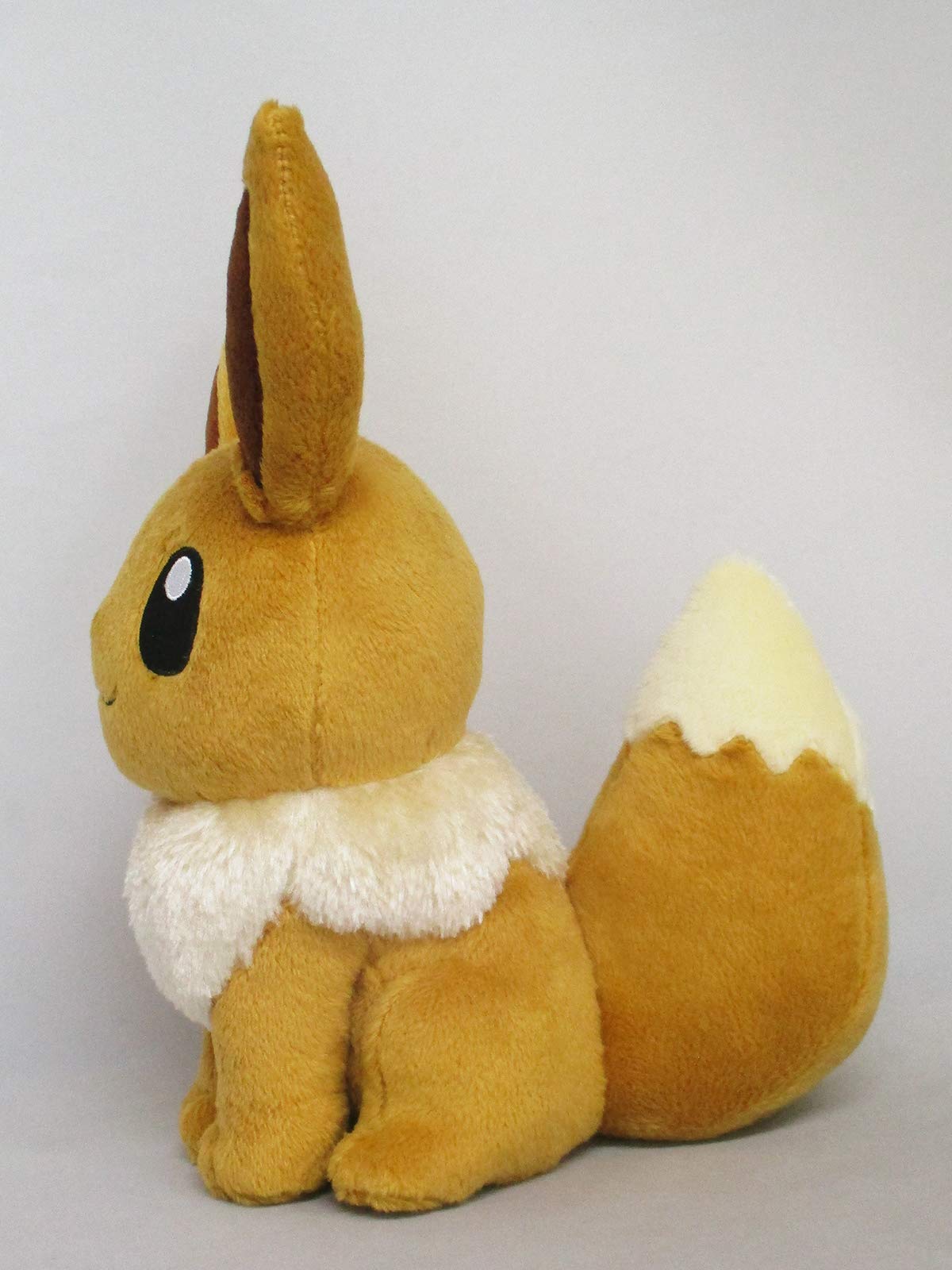 Sanei Eevee plush with cream tail tip ideal as a gift or shelf companion.