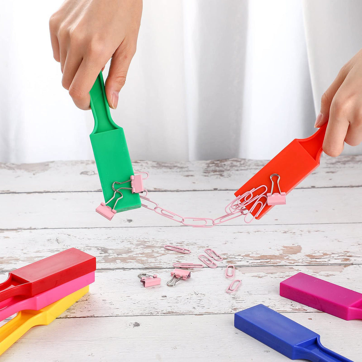 Sanwuta magnetic wands absorbing bingo chips and paperclips during science activities.