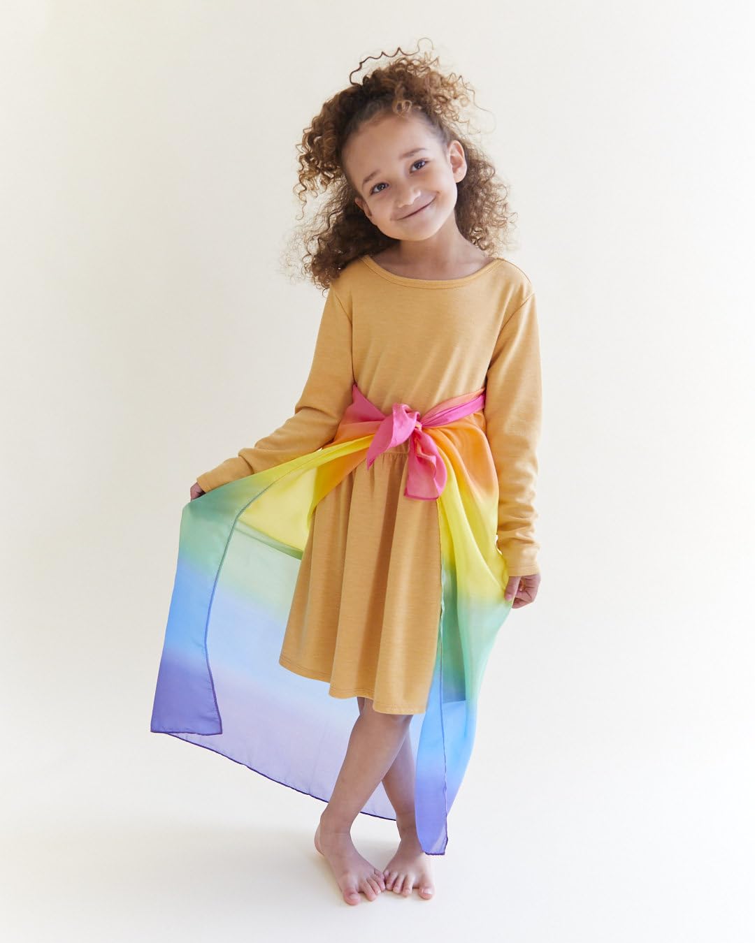 Sarah's Silks Rainbow playsilk folded, inviting tactile exploration.