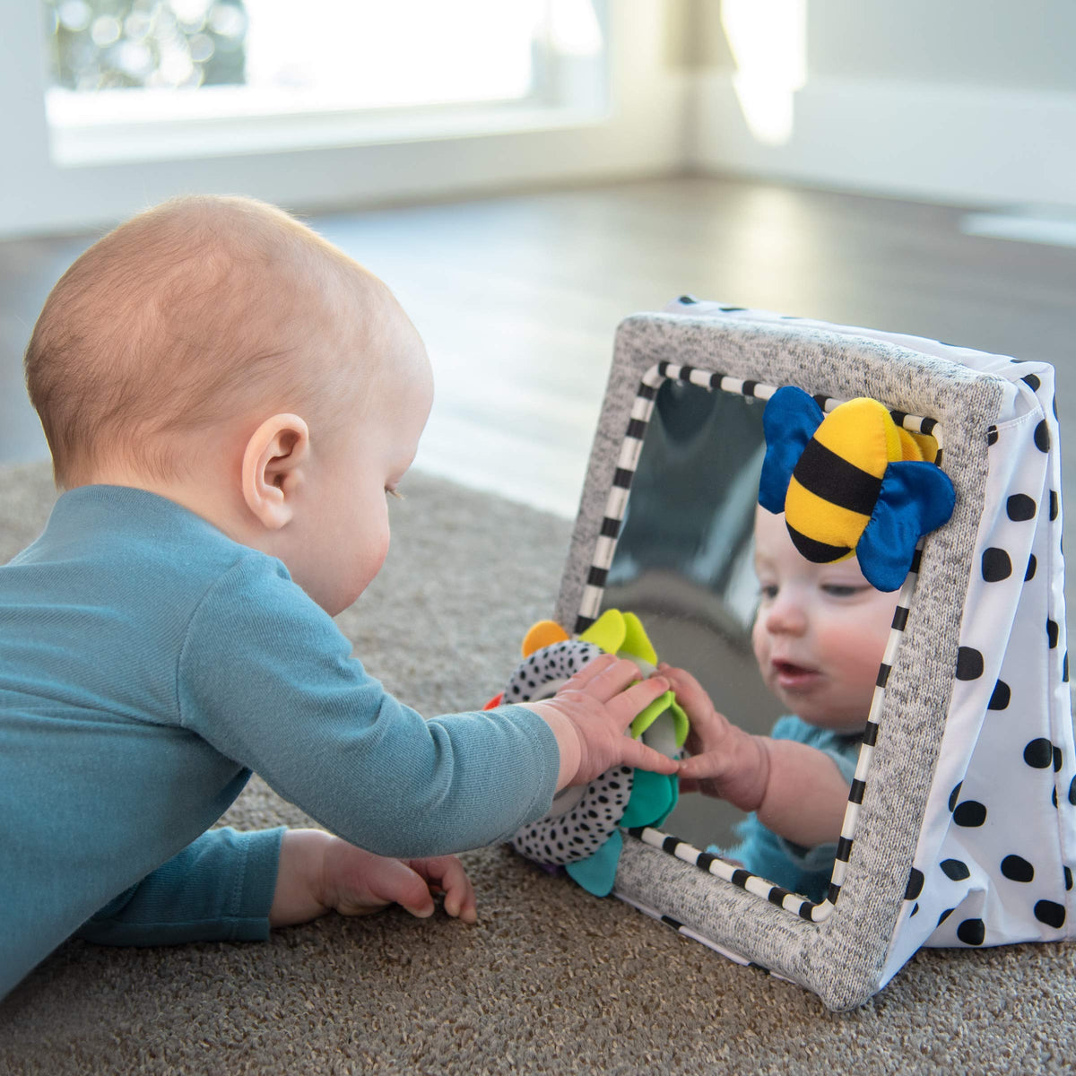 Sassy mirror supports self-awareness and early fine motor exploration.