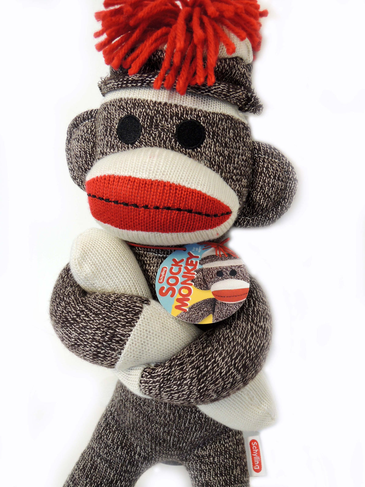 schylling sock monkey with hat and red pompom, nostalgic charm for display and play.