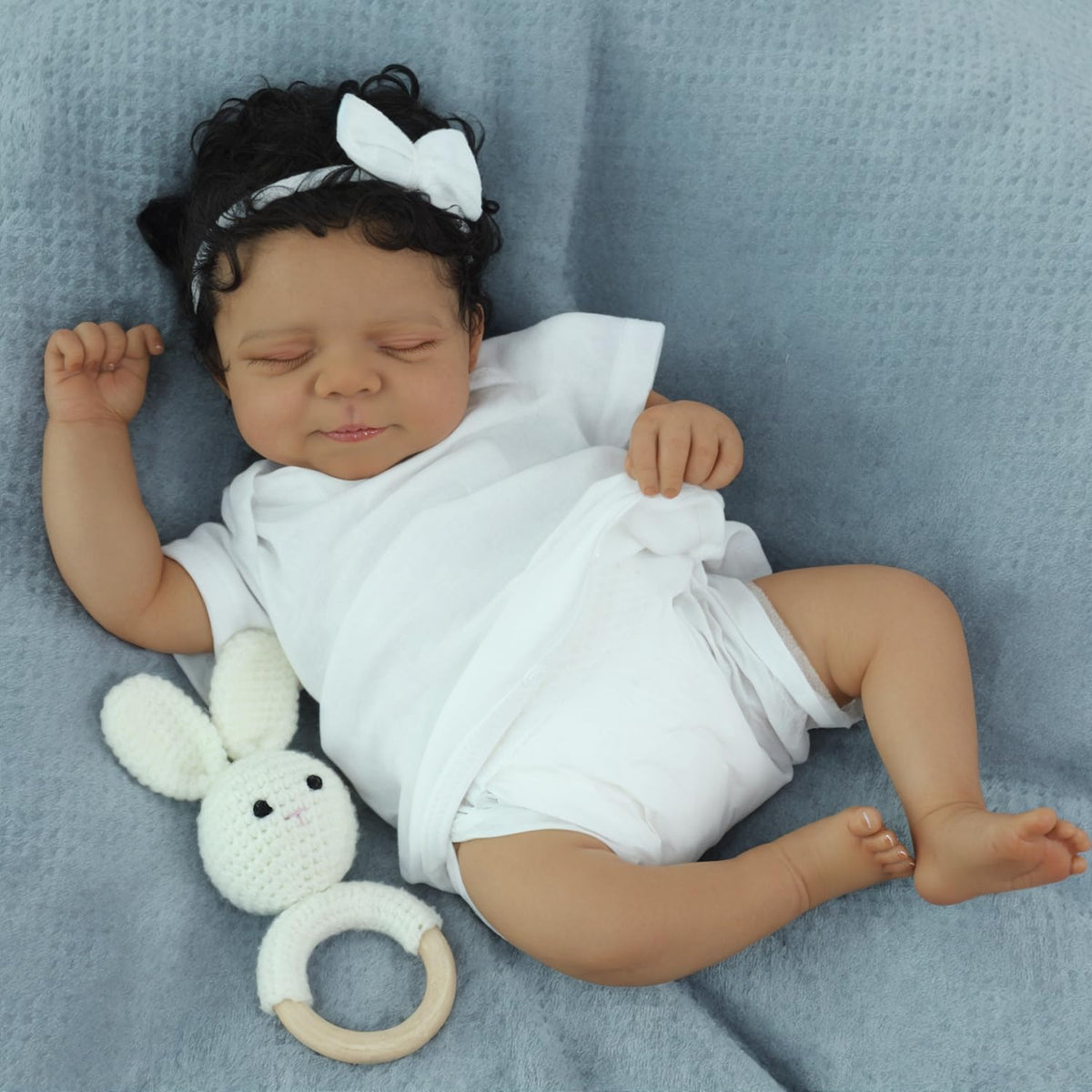 SCOM Reborn Baby Doll Black Boy in infant onesie for gentle play.