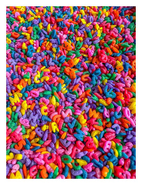 Sensory-N-Stuff rainbow alphabet pasta in a bin for tactile exploration and imaginative play.