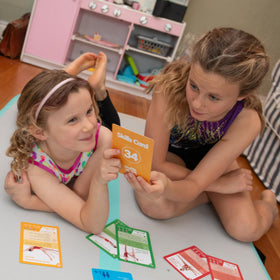 Kids performing stretches from Shuffle Up cards supporting core stability