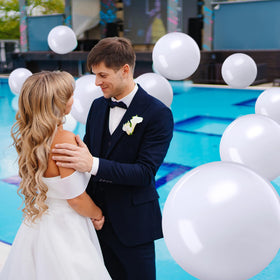 Sinmoe white beach ball deflated for compact storage and easy transport.