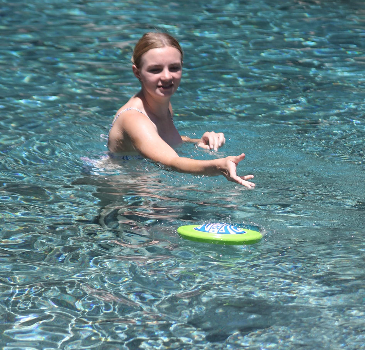 SkimBe Disc Toy on the beach, bright colors for visibility