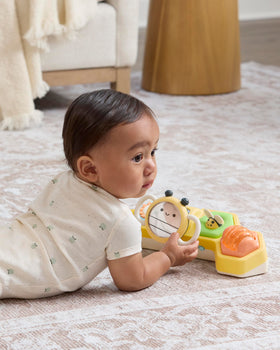 Skip Hop baby mirror supports self-recognition during tummy or seated play.