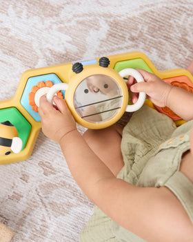 Skip Hop musical flower button offers engaging tunes to spark auditory exploration.