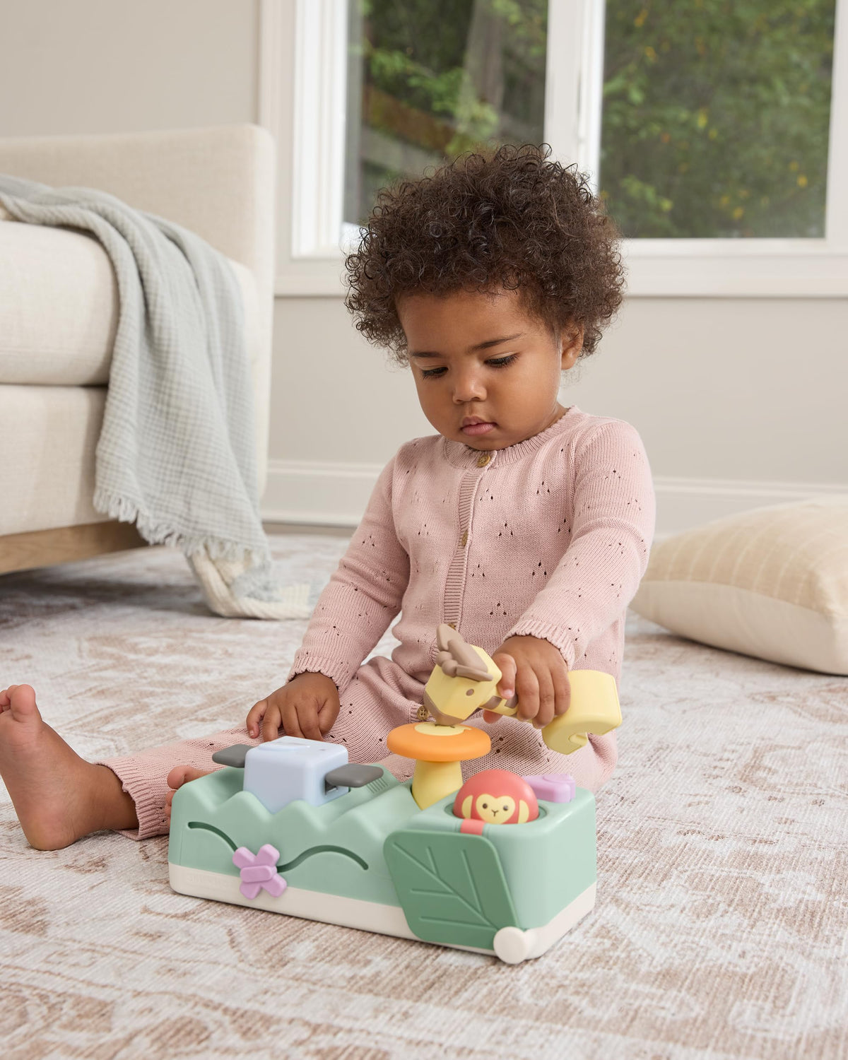 Skip Hop Geometric Wonders peek-a-boo leaf slider sparks fine motor exploration.