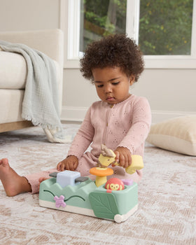 Skip Hop Geometric Wonders peek-a-boo leaf slider sparks fine motor exploration.