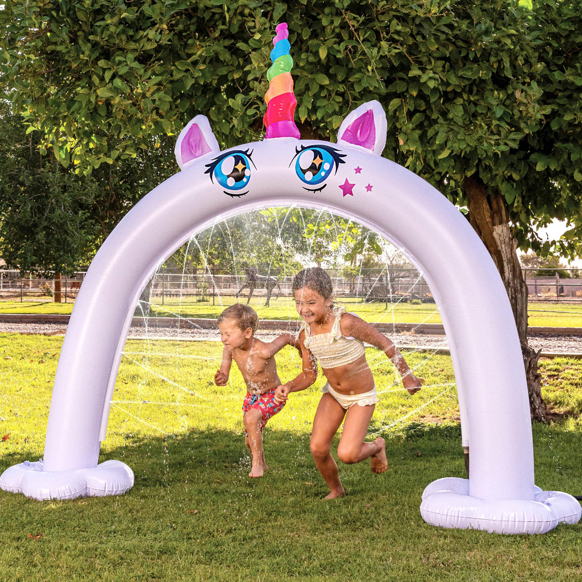 Sloosh unicorn arch sprinkler in action for magical outdoor play