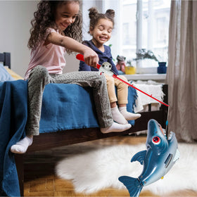 Child catching fish with Small World Toys set in water