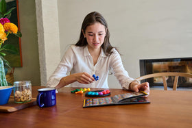 SmartGames IQ Deluxe Circle teen-adult play highlights engaging brain teaser fun.