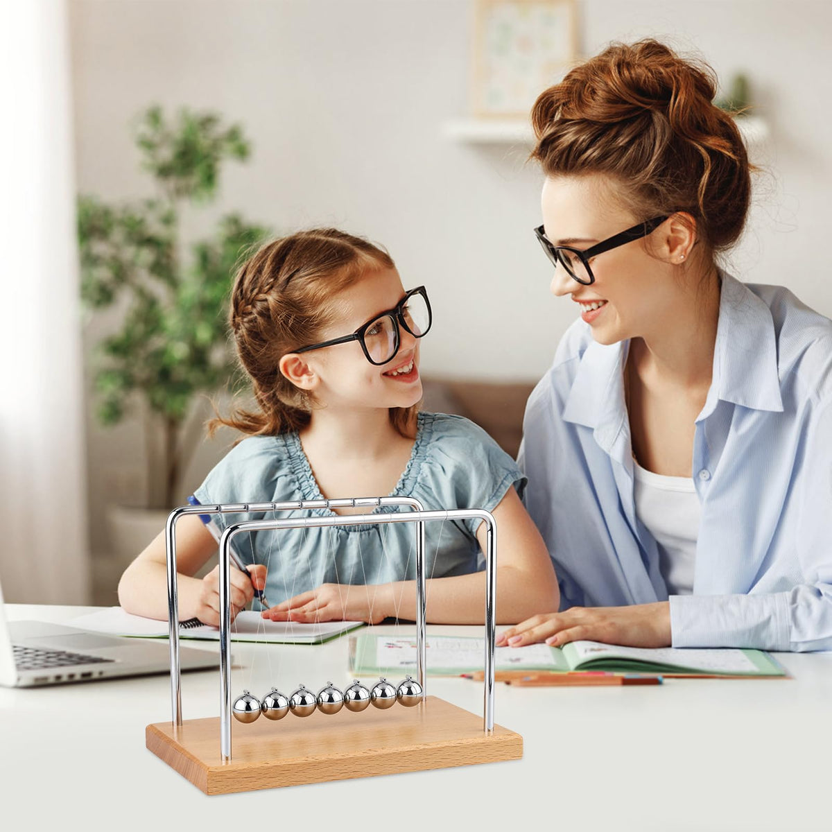 Smilesorg Newton's Cradle used as desk decor to spark curiosity about physics.