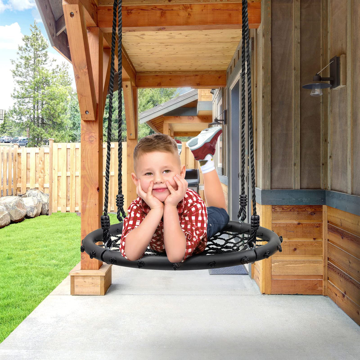 Kids playing on Sorbus Saucer Swing in backyard