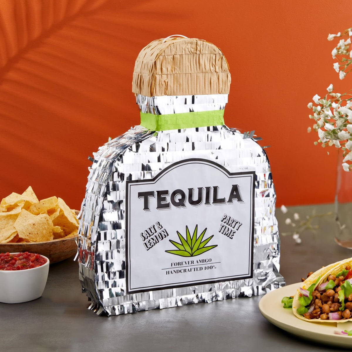 Sparkle and Bash tequila pinata in silver foil serves as a standout centerpiece.
